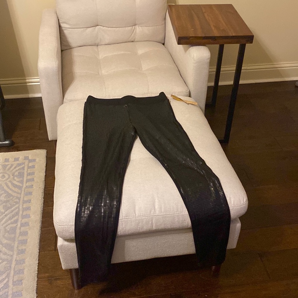 Black sequined leggings on front and nylon/polyester on back.